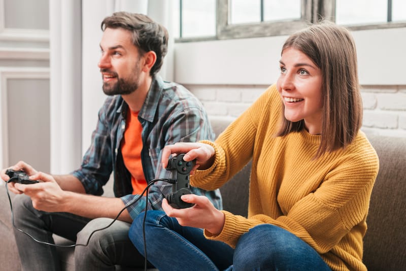 A husband and wife are playing video games together