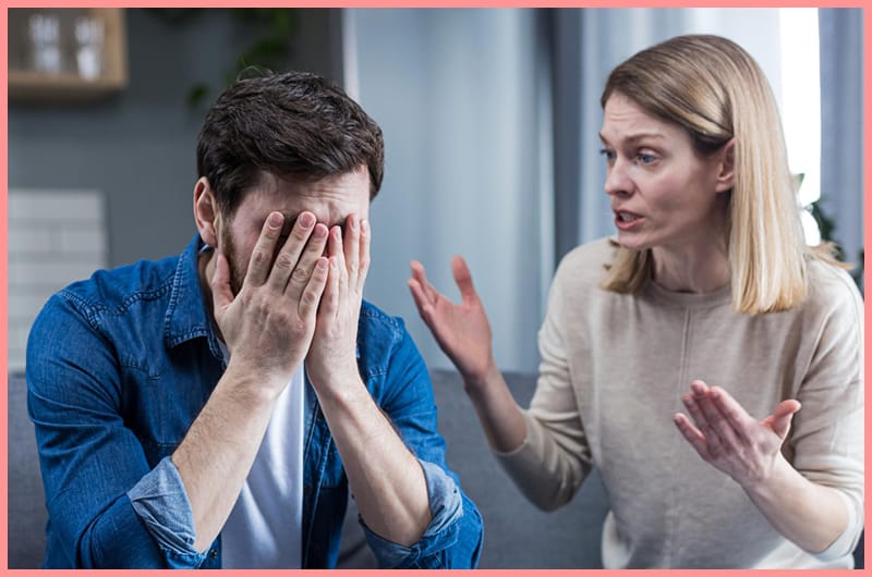 A married is trying to have a conversation with her husband, who has his hands on his face and isn't communicating back.