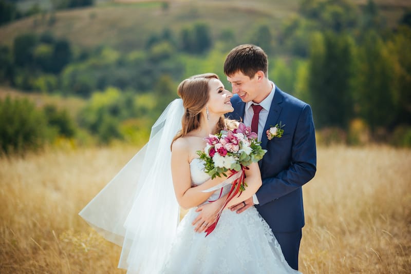 A young couple is getting married outside on the hills