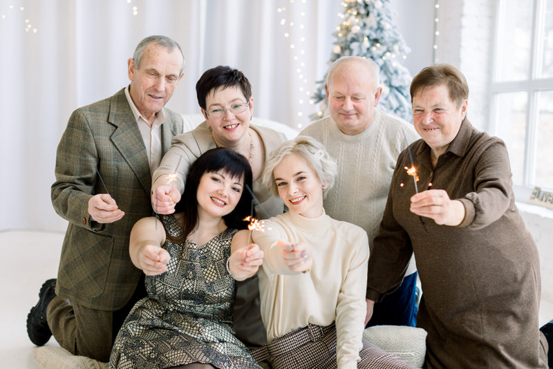A young married couple is celebrating their Christmas holiday with both sets of parents together